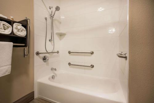 a bathroom with a shower and a bath tub at La Quinta by Wyndham Eugene in Eugene