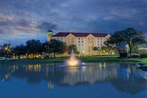 a large building with a fountain in the middle of a pond at La Quinta by Wyndham Jacksonville Butler Blvd in Jacksonville