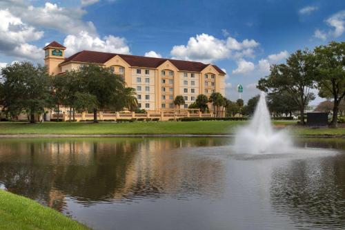 a building with a fountain in the middle of a pond at La Quinta by Wyndham Jacksonville Butler Blvd in Jacksonville