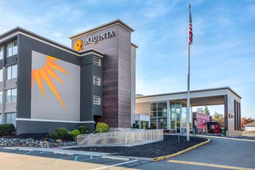 a building with an american flag in front of it at La Quinta by Wyndham Clifton/Rutherford in Clifton