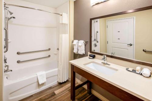 a bathroom with a sink and a tub and a mirror at La Quinta by Wyndham Durango in Durango