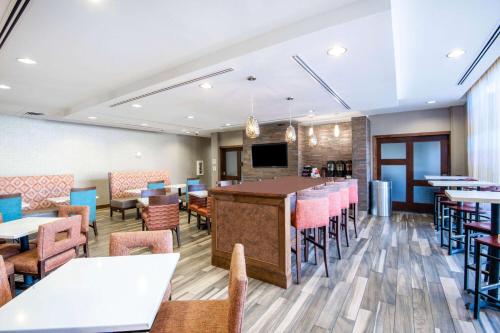 a restaurant with tables and chairs and a bar at La Quinta by Wyndham Durango in Durango