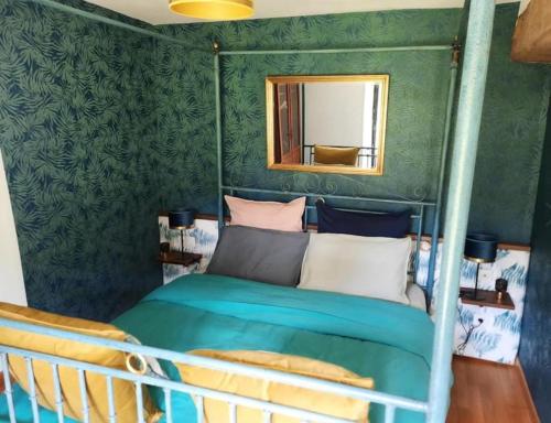 a bedroom with a bunk bed with a mirror at Gîte et Chambres d'Hôtes du Petit Moulin in Réaumur