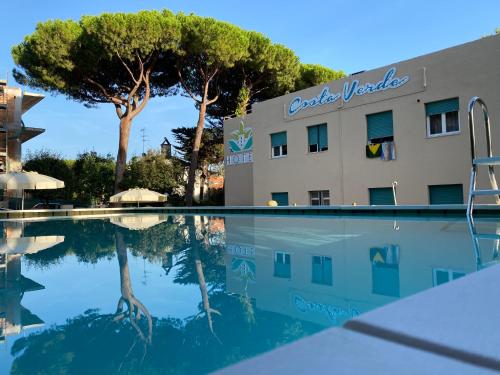 a swimming pool in front of a hotel at Hotel Costa Verde in Castiglioncello