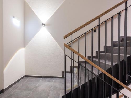 a hallway with stairs and a light on the wall at Chalet Montafon-1 by Interhome in Gaschurn