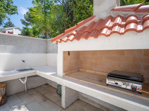 an outdoor kitchen with a stove on a roof at Holiday Home Natali by Interhome in Njivice