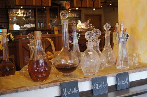 a group of glass bottles sitting on top of a counter at Hotel-Restaurant Laux in Merzig