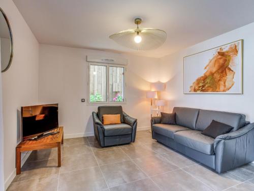 a living room with two couches and a tv at Apartment Domaine Aïga-2 by Interhome in Soorts-Hossegor
