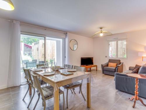 a living room with a table and a couch at Apartment Domaine Aïga-2 by Interhome in Soorts-Hossegor