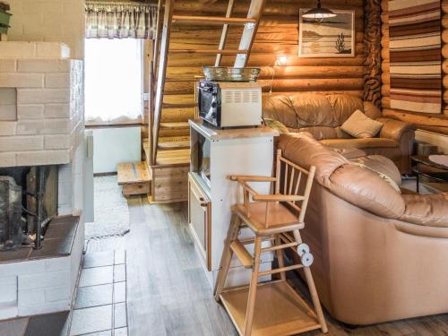 a living room with a couch and a refrigerator at Holiday Home Vuokatticottage c by Interhome in Vuokatti
