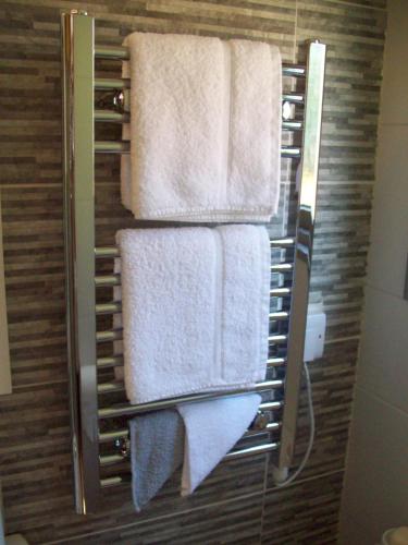 a towel rack with towels on it in a bathroom at Waterloo Farm Shepherds Hut Glamping in Perth