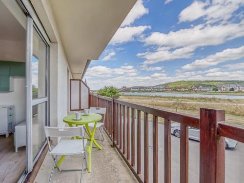d'un balcon avec une table et des chaises et une vue sur l'eau. dans l'établissement Apartment Neptune-2 by Interhome, à Cabourg