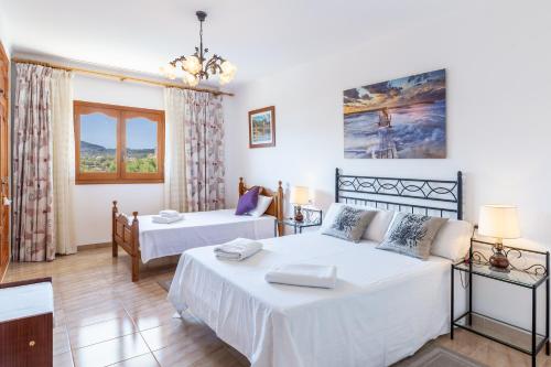 a bedroom with two beds and a couch at Front Line Beach House Up To 6 Guests in Mallorca in Son Serra de Marina