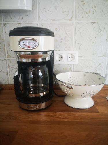 a coffee maker sitting on a counter next to a bowl at VeleLak in Velence