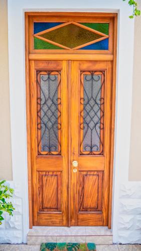 a wooden door with glass windows on a house at Casa da Bungavillia in Machico