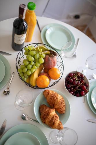 una mesa con platos de comida y una cesta de fruta en Apartment Copernicus No. 25, en Toruń