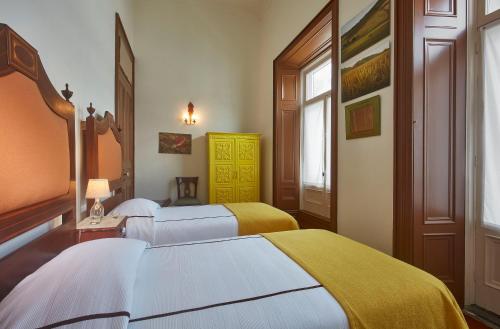 Ένα ή περισσότερα κρεβάτια σε δωμάτιο στο Casadacidade