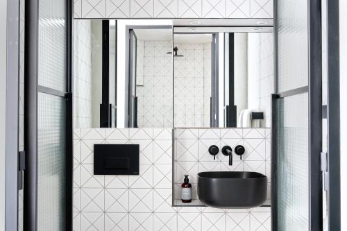 a bathroom with a black sink and a mirror at Staycity Aparthotels London Dalston in London