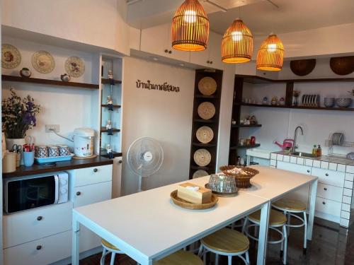 a kitchen with a table with a cake on it at บ้านในกาด-ที่พักน่าน โรงแรมน่าน เที่ยวน่าน in Nan