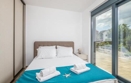 a bedroom with a bed and a large window at VILA STEMARK in Njivice