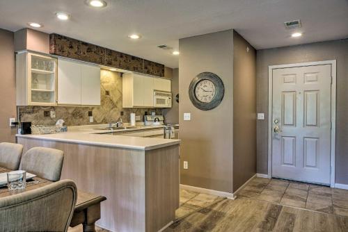 a kitchen with a counter and a sink and a table at Resort Condo in Branson 4 Mi to the 76 Strip! in Branson