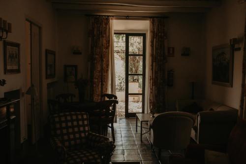 a living room with a door open to a window at Hotel Posada de Valdezufre in Aracena