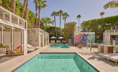 a pool at a resort with palm trees at Viceroy Santa Monica in Los Angeles