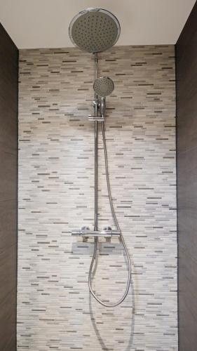 a shower with a shower head in a bathroom at Spacious 65m2 Apartment in the Centre of Eindhoven - R65B in Eindhoven
