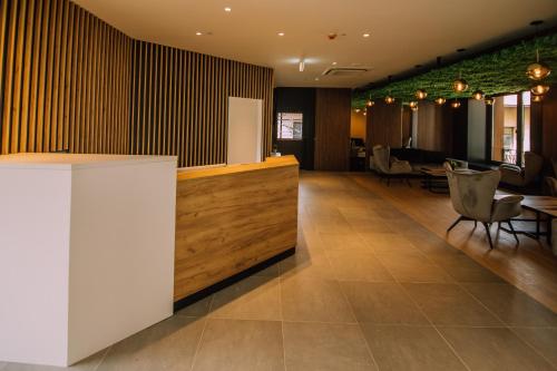 a lobby with a bar and tables and chairs at Hotel Salis in Tuzla