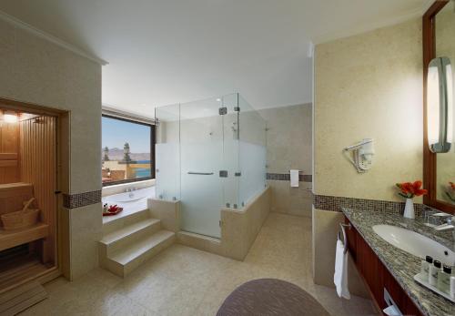 a bathroom with a shower and a sink at InterContinental Aqaba by IHG in Aqaba
