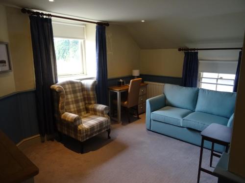 a living room with a couch and a chair and a table at The Groes Inn in Conwy