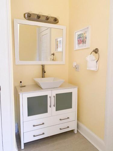 a bathroom with a white sink and a mirror at Authors Key West Guesthouse in Key West