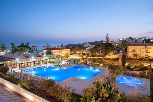 an overhead view of a swimming pool at night at Muthu Clube Praia da Oura in Albufeira
