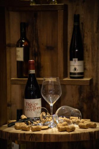 a table with a bottle of wine and a glass at Serendipity Hotel in Sauze dʼOulx
