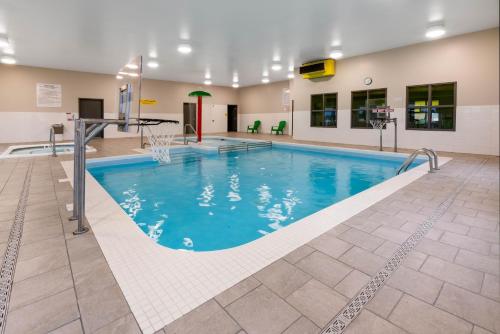 a pool with a basketball hoop in a building at Super 8 by Wyndham Winnipeg East MB in Winnipeg