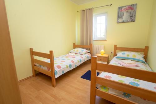 Postel nebo postele na pokoji v ubytování Holiday home Labud