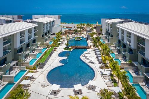 an aerial view of a resort with a swimming pool at Catalonia Grand Costa Mujeres All Suites & Spa - All Inclusive in Cancún