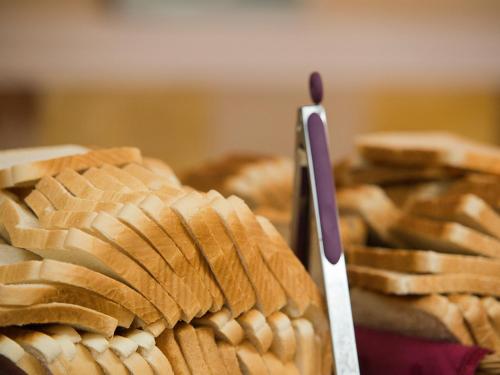 a plate of bread with a knife on top at Bungalows Vistaflor in Maspalomas
