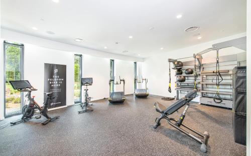 a gym with treadmills and exercise bikes in a room at Hotel Eleo at the University of Florida in Gainesville