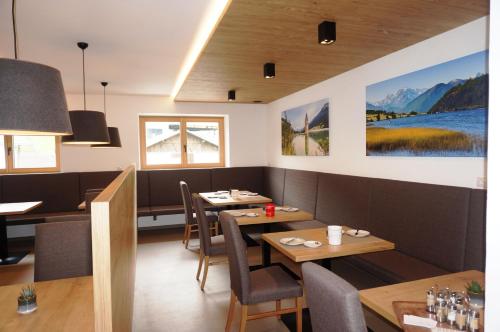 a restaurant with two tables and chairs and a dining room at Pension Sprenger in San Valentino alla Muta