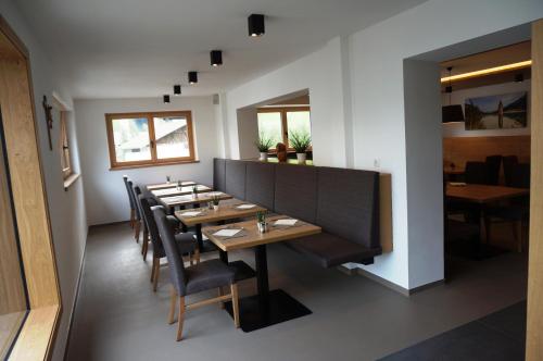 a dining room with a long wooden table and chairs at Pension Sprenger in San Valentino alla Muta