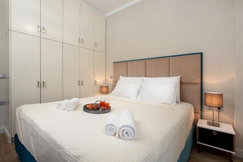 a bedroom with a bed with towels on it at Aria apartment in the heart of Corfu city in Ágios Rókkos