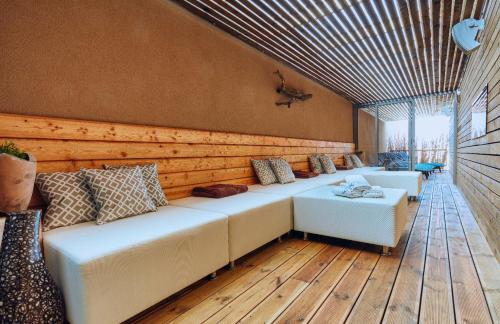 sala de estar con sofá blanco y suelo de madera en Vita Sana Apartments&SPA en Zlín