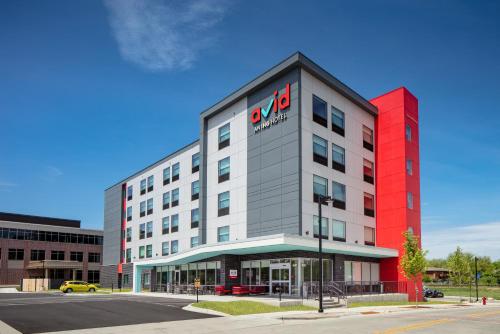 a building with a sign on the side of it at avid hotels - Madison - Monona by IHG in Monona