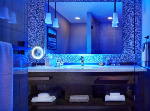 a bathroom with a sink and a large mirror at InterContinental Minneapolis - St. Paul Airport by IHG in Minneapolis