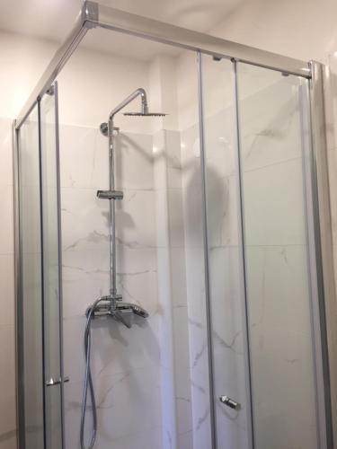 a shower with a glass door in a bathroom at Ponte Romana in Silves