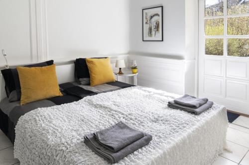 a bedroom with a bed with two towels on it at aday - Apartment suite 1 Aalborg Center in Aalborg