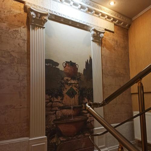 a painting on the wall of a staircase in a building at Hotel Status in Vinnytsya