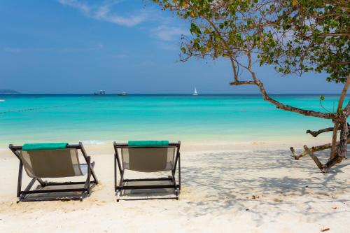 two chairs on a beach with the ocean at Phi Phi Holiday Resort, Leam Tong Beach in Phi Phi Don