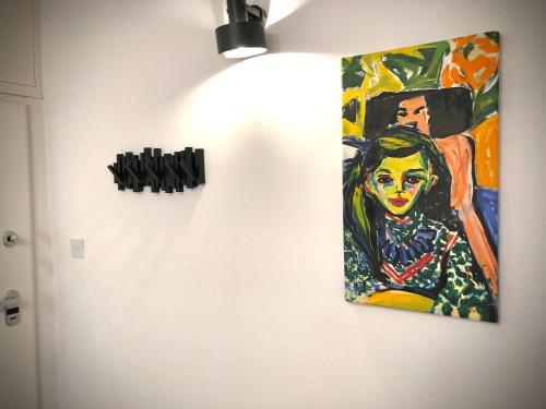 a painting of a woman hanging on a wall at Apartament RadMila2 in Radom